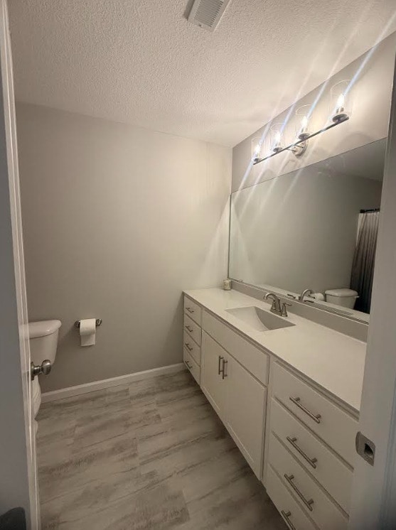3938 Summer Sage Ct, Champaign, IL 61822 - full bathroom with vanity, wood finished floors, and a textured ceiling