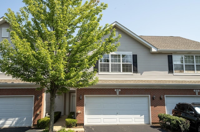 610 N Red Deer Rd, Round Lake, IL 60073 - view of front of property with brick siding, driveway, roof with shingles, and an attached garage