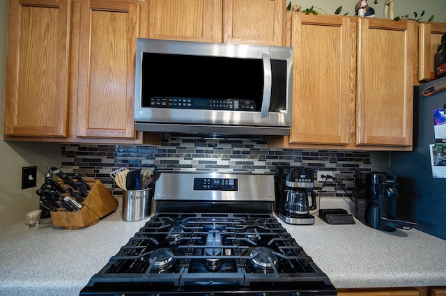 610 N Red Deer Rd, Round Lake, IL 60073 - kitchen with stainless steel appliances, light countertops, and backsplash