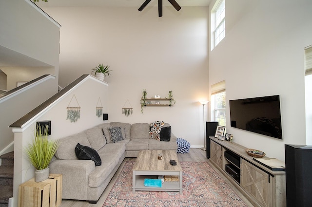 610 N Red Deer Rd, Round Lake, IL 60073 - living room with wood finished floors, ceiling fan, a high ceiling, healthy amount of natural light, and stairway