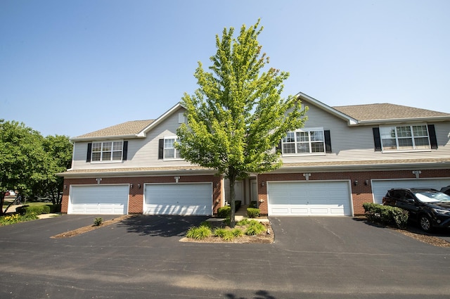 610 N Red Deer Rd, Round Lake, IL 60073 - view of front of property with driveway, an attached garage, and brick siding