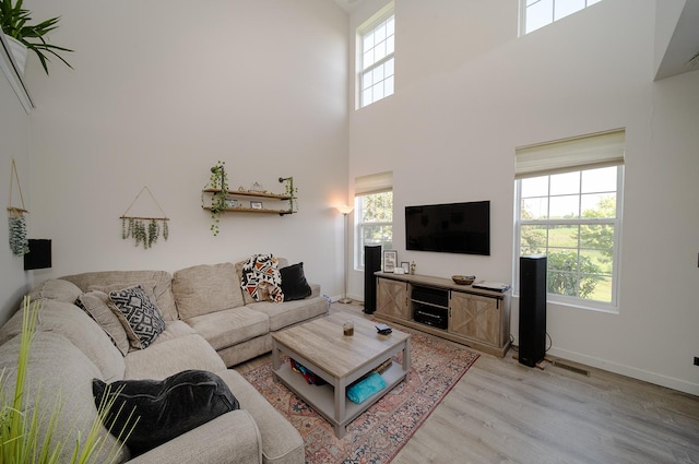 610 N Red Deer Rd, Round Lake, IL 60073 - living room featuring healthy amount of natural light, light wood-style flooring, and a high ceiling