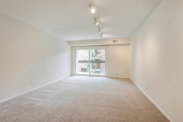 1738 Chicago Ave Unit 303, Evanston, IL 60201 - spare room featuring light colored carpet and track lighting