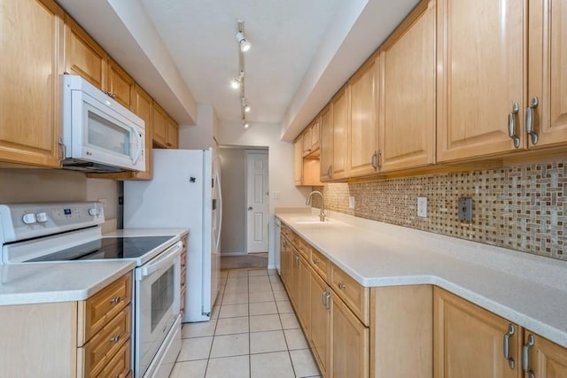 1738 Chicago Ave Unit 303, Evanston, IL 60201 - kitchen featuring white appliances, backsplash, light countertops, light tile patterned floors, and light brown cabinetry