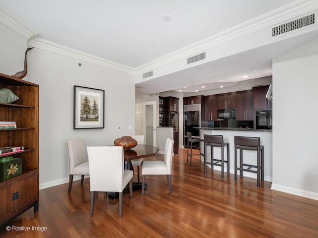 21 E Huron St Unit 1106, Chicago, IL 60611 - dining space with dark wood-style flooring, crown molding, and recessed lighting