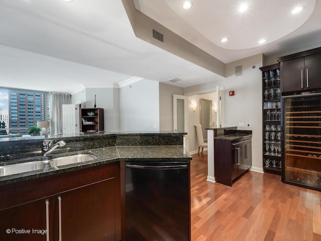 21 E Huron St Unit 1106, Chicago, IL 60611 - kitchen featuring dishwashing machine, beverage cooler, light wood-style flooring, dark stone countertops, and ornamental molding