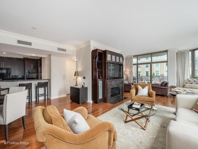 21 E Huron St Unit 1106, Chicago, IL 60611 - living room featuring ornamental molding, wood finished floors, and a premium fireplace