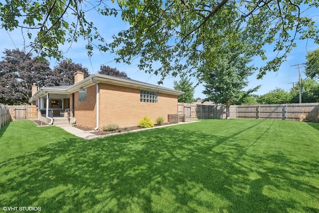 1 E Milburn Ave, Mount Prospect, IL 60056 - back of property with brick siding, a chimney, and a fenced backyard