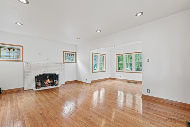 619 N 4th Ave, Maywood, IL 60153 - unfurnished living room featuring light wood finished floors, recessed lighting, and a fireplace