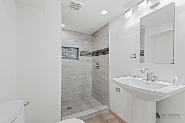 619 N 4th Ave, Maywood, IL 60153 - full bathroom featuring a tile shower, wood finished floors, and recessed lighting