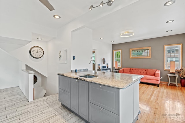 619 N 4th Ave, Maywood, IL 60153 - kitchen featuring gray cabinetry, light wood-style floors, light stone countertops, open floor plan, and recessed lighting