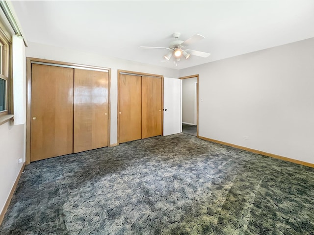 17225 Laflin Ave, East Hazel Crest, IL 60429 - unfurnished bedroom featuring multiple closets, dark colored carpet, and a ceiling fan