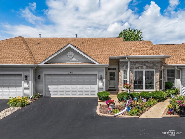 21610 W Empress Ln, Plainfield, IL 60544 - view of property featuring driveway, an attached garage, and roof with shingles