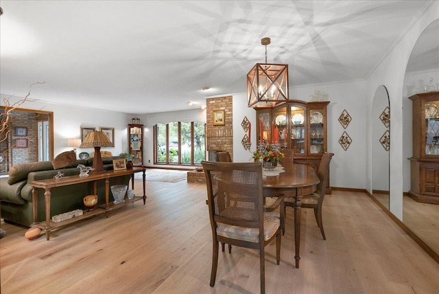 25316 E 1100 N Rd, Downs, IL 61736 - dining room featuring arched walkways, light wood-type flooring, crown molding, and a chandelier