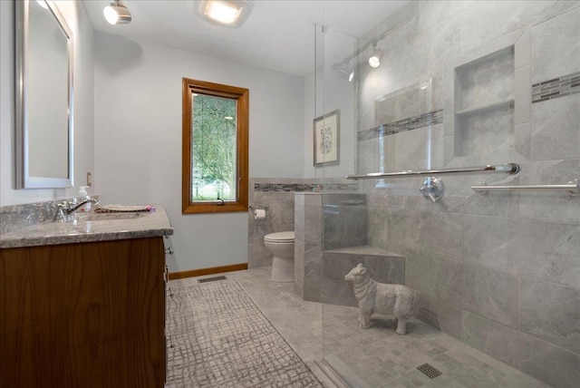 25316 E 1100 N Rd, Downs, IL 61736 - full bathroom with a tile shower, vanity, tile walls, and tile patterned floors