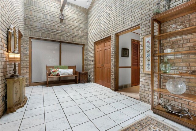 25316 E 1100 N Rd, Downs, IL 61736 - bedroom with a high ceiling, brick wall, and a closet
