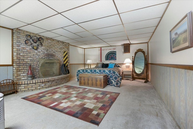 25316 E 1100 N Rd, Downs, IL 61736 - living room featuring carpet flooring, a paneled ceiling, a fireplace, a wainscoted wall, and wooden walls