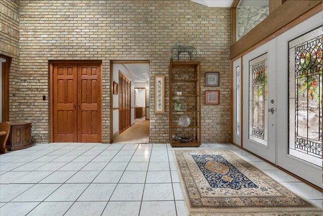 25316 E 1100 N Rd, Downs, IL 61736 - entryway featuring brick wall, a towering ceiling, and french doors