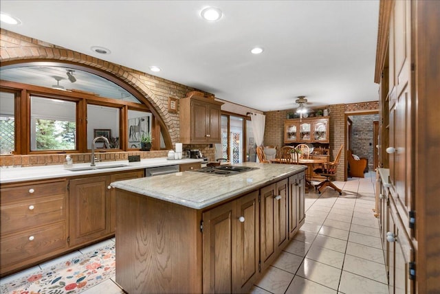 25316 E 1100 N Rd, Downs, IL 61736 - kitchen featuring plenty of natural light, a kitchen island, brick wall, arched walkways, and ceiling fan