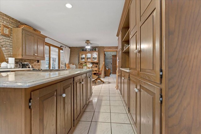 25316 E 1100 N Rd, Downs, IL 61736 - kitchen with brick wall, open shelves, a ceiling fan, stainless steel gas stovetop, and light stone counters