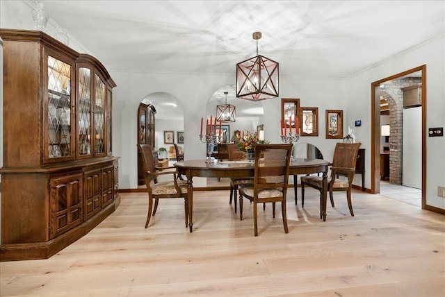 25316 E 1100 N Rd, Downs, IL 61736 - dining room featuring arched walkways, ornamental molding, light wood-type flooring, and a chandelier