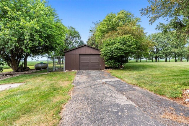 25316 E 1100 N Rd, Downs, IL 61736 - view of front of home with a gate, a front yard, a garage, an outbuilding, and driveway