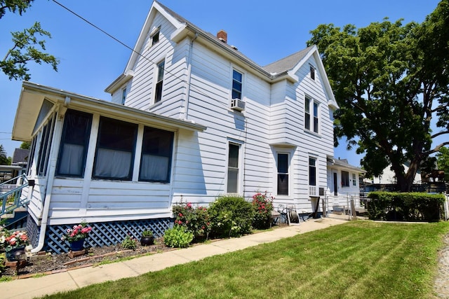 915 W Olive St, Bloomington, IL 61701 - view of front of property with a front lawn, a chimney, and a sunroom