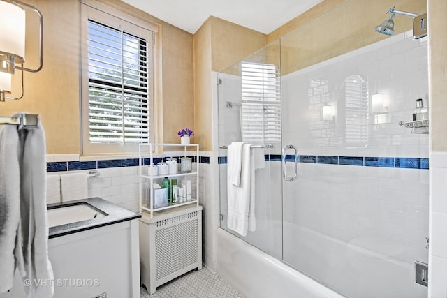 3800 N Lake Shore Dr Unit 1B, Chicago, IL 60613 - full bath with radiator, tile walls, bath / shower combo with glass door, vanity, and tile patterned floors