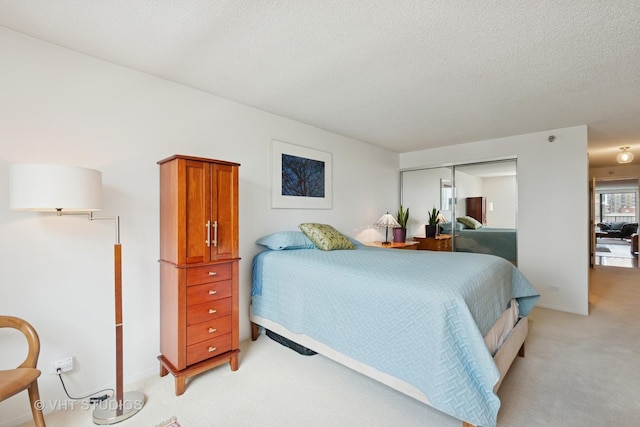 1250 N Dearborn St Unit 11C, Chicago, IL 60610 - bedroom featuring light colored carpet, a closet, and a textured ceiling