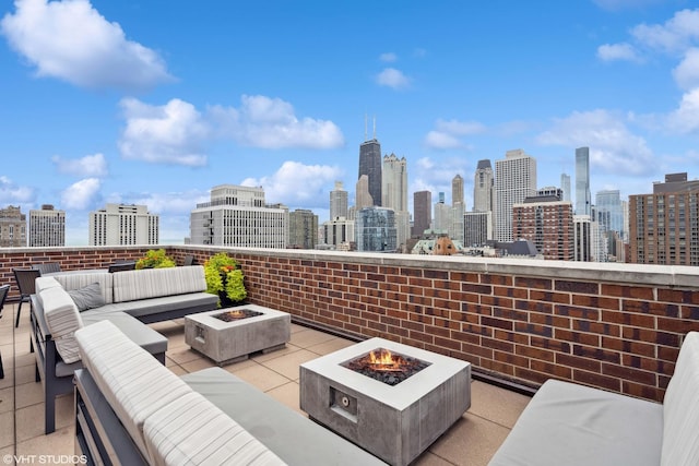 1250 N Dearborn St Unit 11C, Chicago, IL 60610 - view of patio / terrace with an outdoor living space with a fire pit and a skyline view