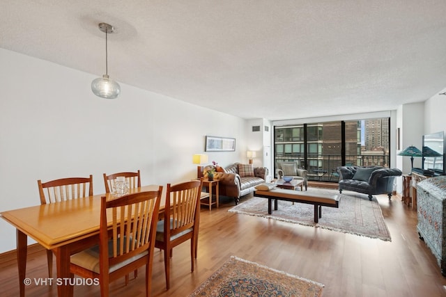 1250 N Dearborn St Unit 11C, Chicago, IL 60610 - dining room with wood finished floors and a textured ceiling