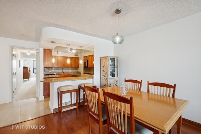 1250 N Dearborn St Unit 11C, Chicago, IL 60610 - dining room featuring a textured ceiling and baseboards