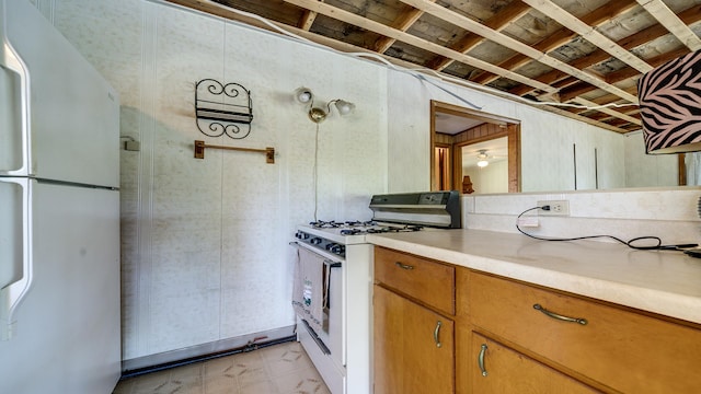 7198 S Rock Nation Rd, Dixon, IL 61021 - kitchen featuring white appliances, light countertops, and brown cabinetry