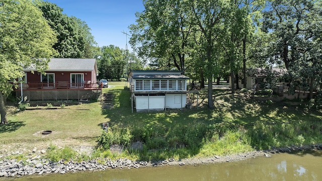7198 S Rock Nation Rd, Dixon, IL 61021 - view of green lawn with a deck with water view and a garage