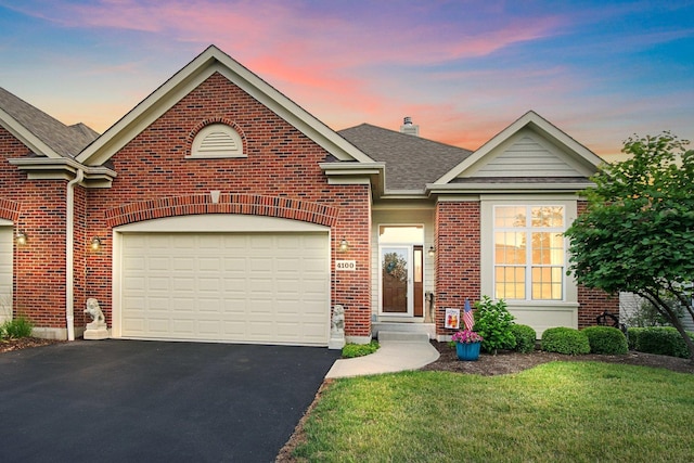 4100 Coyote Lakes Cir, Lake In The Hills, IL 60156 - traditional home with brick siding, driveway, roof with shingles, a front yard, and a chimney
