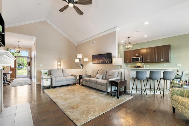 4100 Coyote Lakes Cir, Lake In The Hills, IL 60156 - living room featuring a chandelier, a ceiling fan, dark wood-style flooring, vaulted ceiling, and crown molding