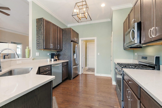 4100 Coyote Lakes Cir, Lake In The Hills, IL 60156 - kitchen with appliances with stainless steel finishes, light countertops, crown molding, dark brown cabinets, and a chandelier