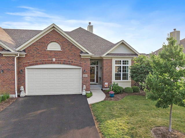 4100 Coyote Lakes Cir, Lake In The Hills, IL 60156 - traditional-style house featuring asphalt driveway, brick siding, a chimney, and roof with shingles