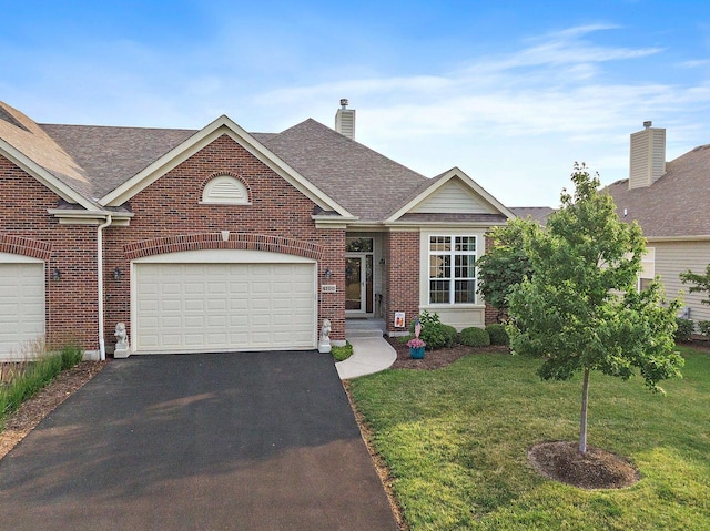 4100 Coyote Lakes Cir, Lake In The Hills, IL 60156 - view of front facade with brick siding, asphalt driveway, a front lawn, and roof with shingles