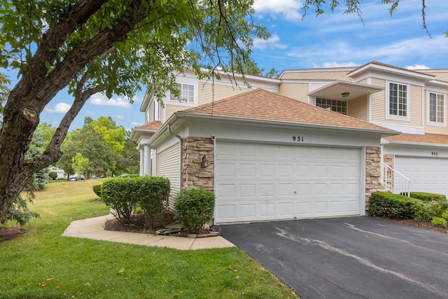 931 Mesa Dr, Elgin, IL 60123 - view of property exterior with stone siding, asphalt driveway, roof with shingles, a yard, and an attached garage