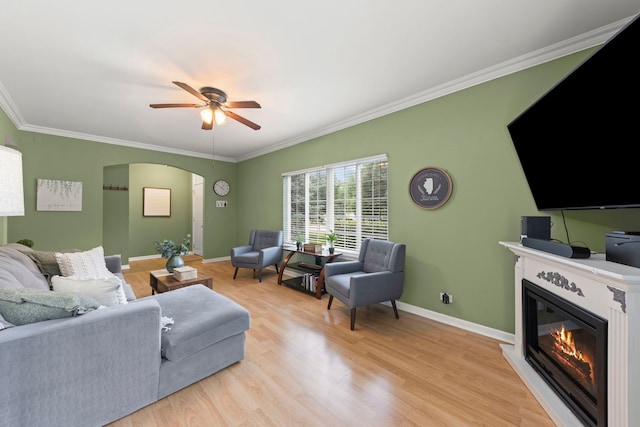 931 Mesa Dr, Elgin, IL 60123 - living area with a ceiling fan, arched walkways, a glass covered fireplace, ornamental molding, and light wood finished floors