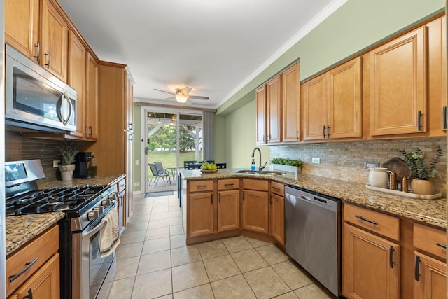 931 Mesa Dr, Elgin, IL 60123 - kitchen with appliances with stainless steel finishes, light tile patterned flooring, decorative backsplash, crown molding, and a peninsula