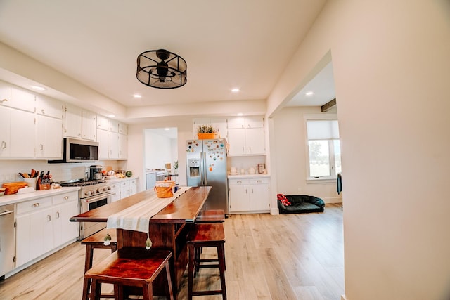 1533 E 1400 N Rd, Crescent City, IL 60928 - kitchen featuring stainless steel appliances, light wood finished floors, recessed lighting, light countertops, and white cabinets