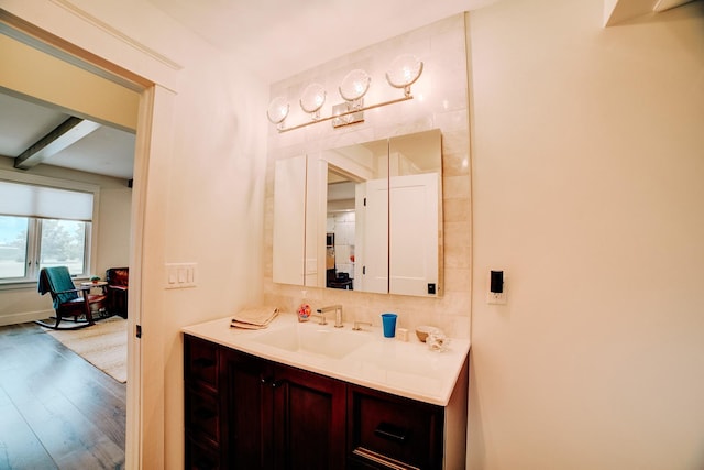 1533 E 1400 N Rd, Crescent City, IL 60928 - bathroom with wood finished floors, backsplash, vanity, and beam ceiling