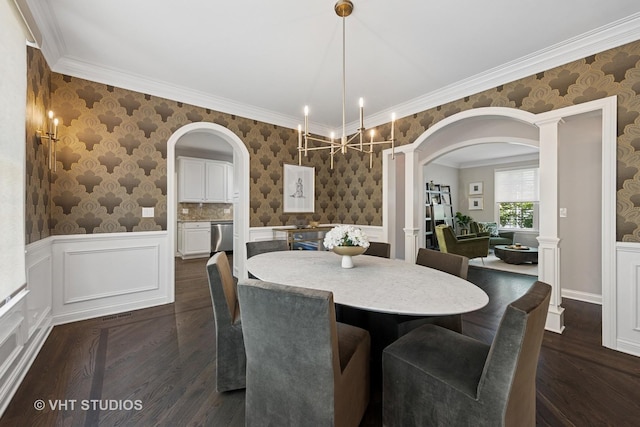 128 W Windsor Ave, Lombard, IL 60148 - dining space featuring arched walkways, dark wood-type flooring, a chandelier, a wainscoted wall, and wallpapered walls