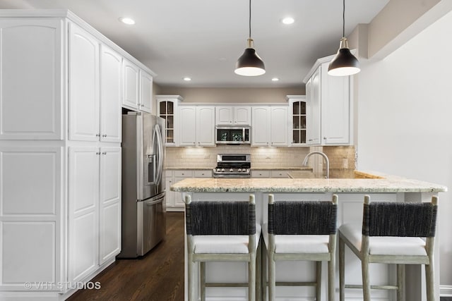 128 W Windsor Ave, Lombard, IL 60148 - kitchen featuring appliances with stainless steel finishes, a peninsula, glass insert cabinets, dark wood-style floors, and decorative backsplash