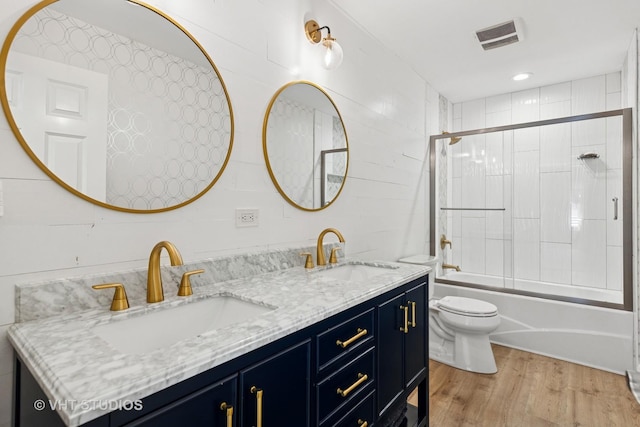 128 W Windsor Ave, Lombard, IL 60148 - bathroom featuring double vanity, shower / bath combination with glass door, and wood finished floors