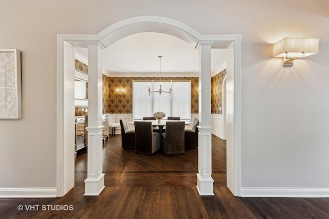 128 W Windsor Ave, Lombard, IL 60148 - dining area featuring ornate columns, wainscoting, a decorative wall, and dark wood-type flooring