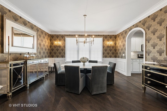 128 W Windsor Ave, Lombard, IL 60148 - dining space with wallpapered walls, a chandelier, dark wood-style floors, arched walkways, and wainscoting