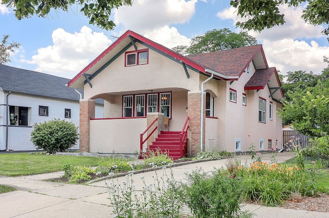 296 N Addison Ave, Elmhurst, IL 60126 - view of front facade with stucco siding, a porch, a shingled roof, and stairway